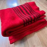 Folded thick red wool blanket showing texture and thickness