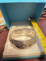 Bracelet in presentation box with tape measure showing width