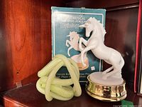 Porcelain unicorn music box, original box, green blown glass knot