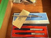 Cross ballpoint pen on blue box, Parker duo in black box