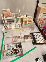 Overview showing dresser-vanity, tea set, bathroom set, window kits, curtain rods, patterns, hardware