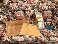 Overall lot showing parchment facsimiles, plastic bin with boxed note cards, and blue box of postcards