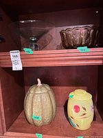 Group shot showing amber glass bowl, clear glass compote (not in lot), pumpkin canister, yellow jar
