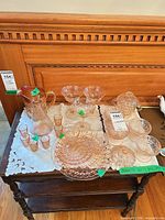 Group shot of entire pink Depression glass assortment on table