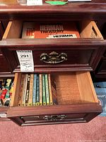 Drawer showing stack of James Bond paperbacks and Herman booklets