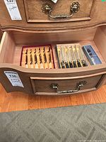 Drawer view of both knife sets and boxed pewter piece