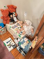 Overall lot showing plush bears, dolls, cut-outs, books and storage case