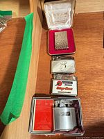 Four lighters arranged vertically, two in boxes, showing overall lot