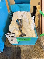 Single goblet in tissue-lined box showing exterior finish and ornate stem