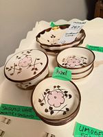 Stacked small bowls, scalloped dish, inventory label visible