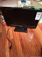 Front view of 19" Sanyo LCD TV on stand with power cord visible