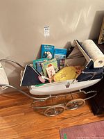 Overall lot showing pram filled with books, doll, Snoopy and accessories