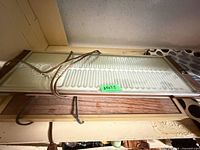 Two stacked electric warming trays, cords visible