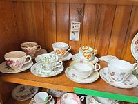 Shelf view showing all five teacup and saucer sets