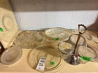 Overall lot showing multiple pressed glass plates, oval tray and relish server