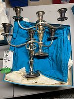 Both candelabra laid in box showing overall form and finish