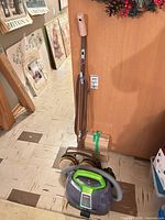 Bissell cleaner and Sunbeam floor buffer standing together