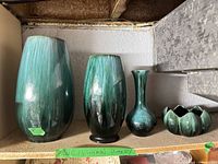 Four Blue Mountain Pottery pieces on shelf