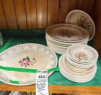 Overall view of platter, stacked plates and bowls on shelf