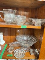 Group view on shelving showing pitcher, small bowls, compote, ashtrays and dish