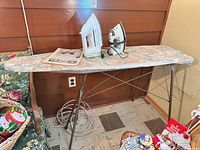 Full view of ironing board with both irons on top