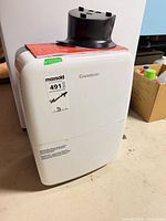 Front view of Garrison dehumidifier showing brand label and MaxSold sticker