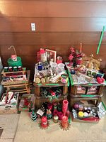 overview of entire lot on two tables showing large quantity of candles and holders