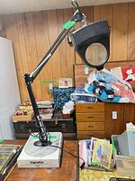 Full view of adjustable lamp on box with arm extended