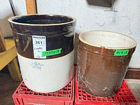 Both crocks side by side on crates