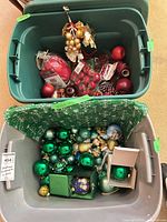 Overview of two storage bins filled with assorted ornaments