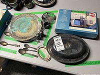 Overview of lot showing oval dish, boxed spoon set, tray, flatware and small pieces