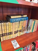 Shelf view showing Nancy Drew yellow-spine hardcovers, Peanuts paperbacks and additional titles