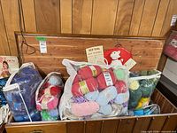 Chest containing three clear bags of assorted yarn skeins
