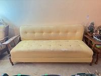 Sofa in couch position showing upholstery and button tufting