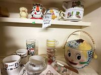 Cabinet view showing majority of lot items grouped together