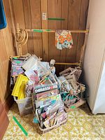 Overall lot with bins of needlepoint kits, bamboo frame, decorative spinning wheel