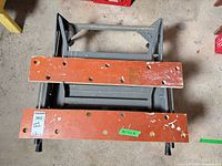 folded workbench top view showing plywood surfaces, dog holes, and steel frame