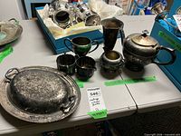 Group shot showing all nine silver-plated pieces