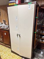 Front view of Sunshine metal storage cabinet showing beige double doors and handles