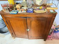 Front view showing two paneled doors and latch