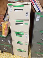 Full view of beige 4-drawer metal filing cabinet