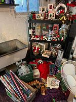 Wide shot of shelving with ornaments, wreath, lights and decorations