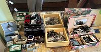 Overview of multiple jewellery boxes filled with assorted costume jewellery on table