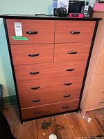 Front view of dresser showing eight drawers, laminate finish, plastic handles