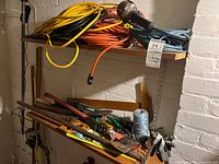 Shelf with extension cords and assorted tools