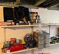 Shelf with paint trays, brushes, roller handles, sandpaper pack