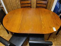 Top view of oval dining table with six chairs