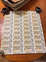 Full view of uncut 5 x 8 sheet of $1 Canadian bills