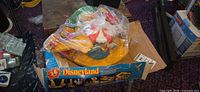 Play set components bagged together on top of original Disneyland box