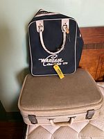 Wardair Canada carry-on on top of beige vanity case
